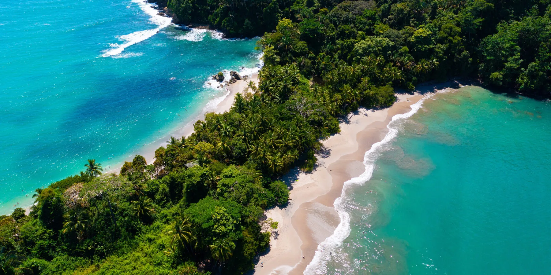 Aerial view of Costa Rica coastline with turquoise water and lush green jungle